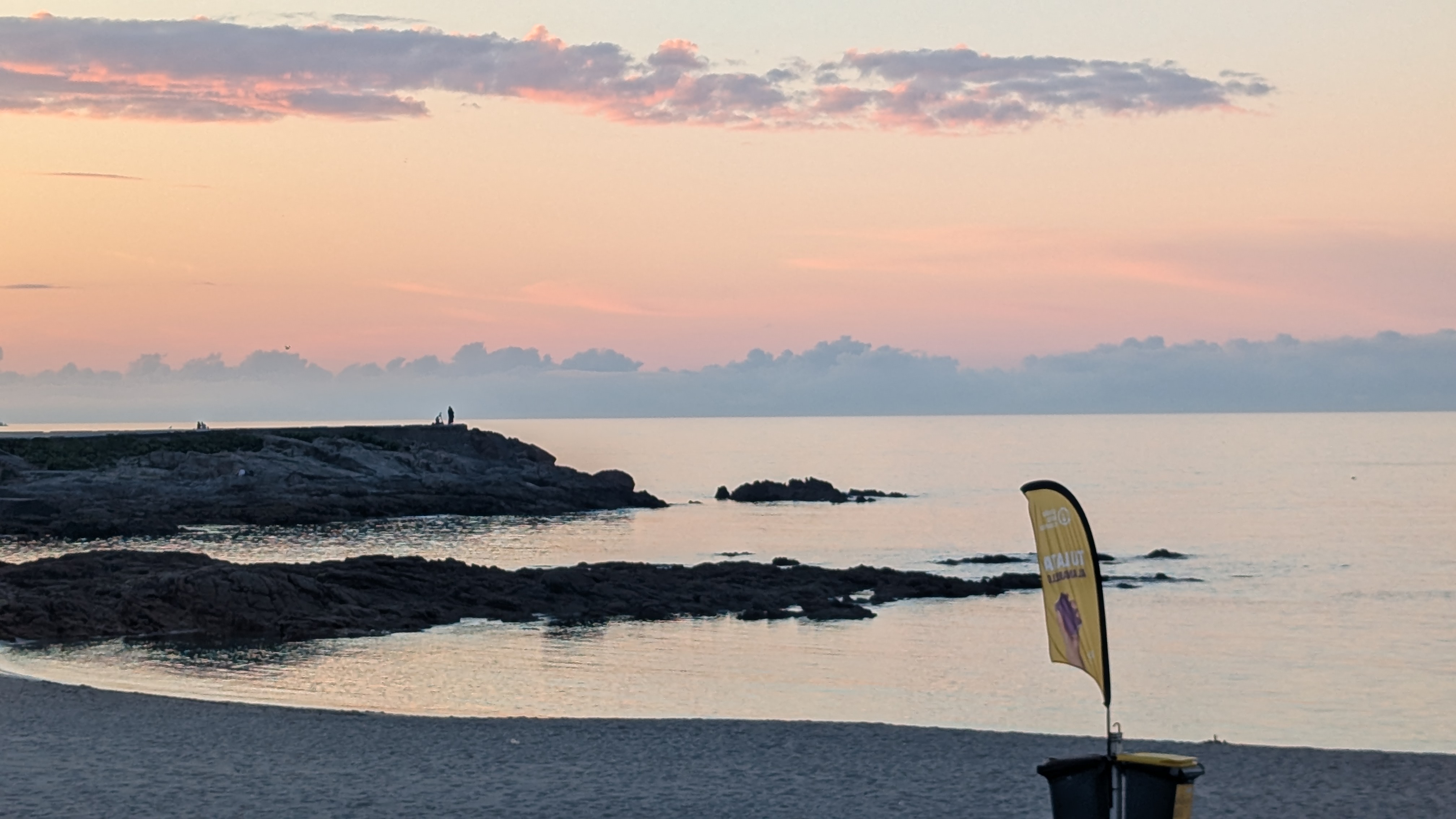 Photo of a small beach at sun set in A Coruña.