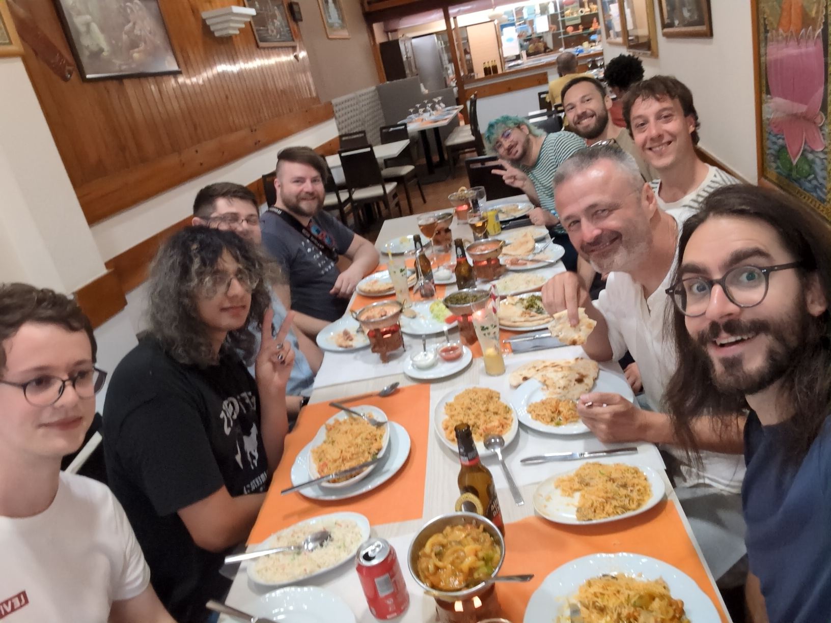 Photo of around 10 GNOME community members sat down eating dinner at a local Indian restaurant, including me second on the left c: